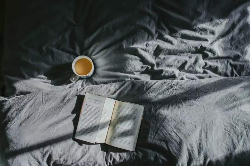 Evening wind down routine for improved sleep hygiene - book and tea